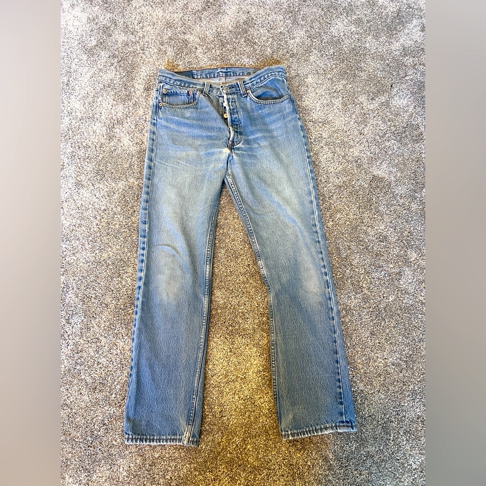 Red-tab original button fly Levi’s 501s. Light wash, naturally distressed